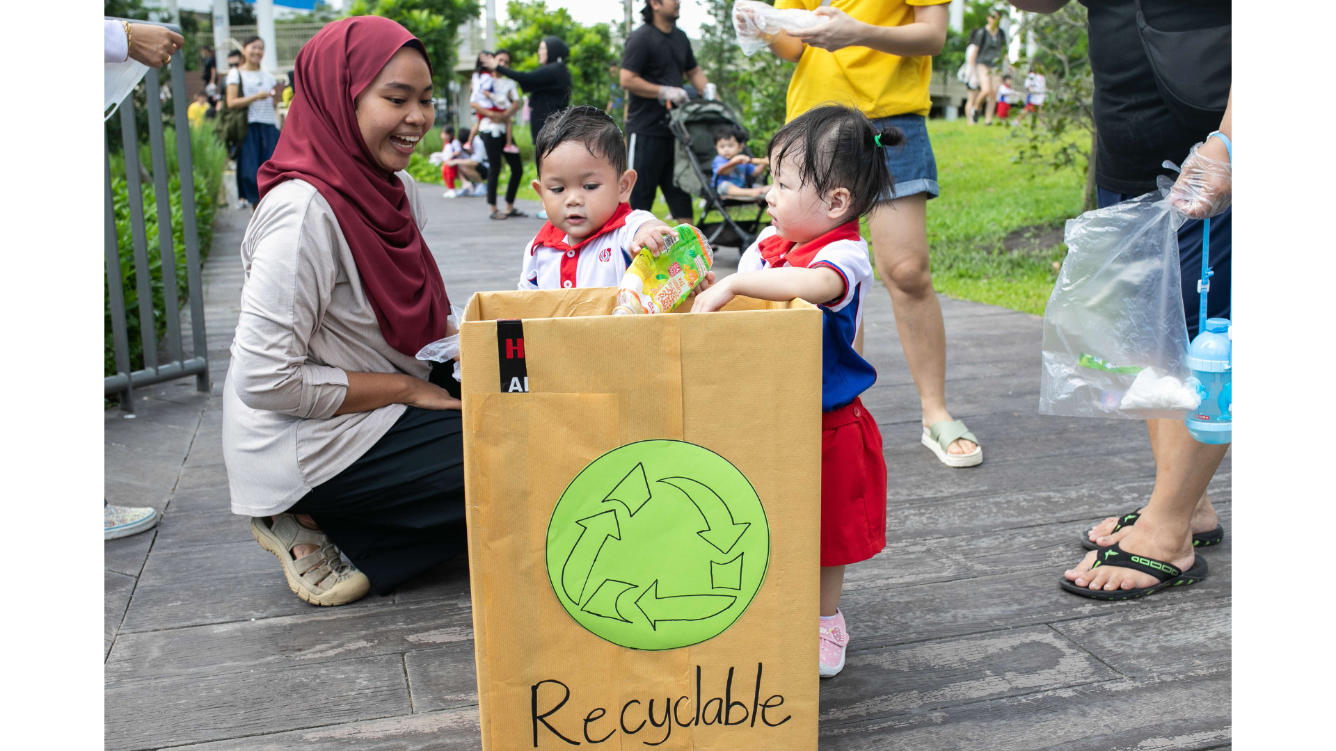 young children place recyclables in a customised recyclable box